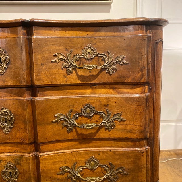 18th c. French hand carved walnut French serpentine commode with elaborate bronze handles. Three shaped front drawers with...