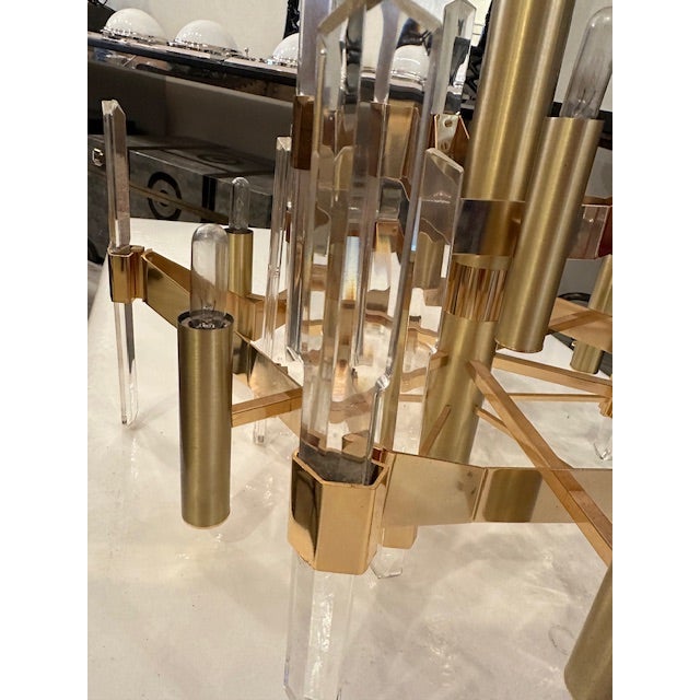This is a mid century chandelier by Gaetano Sciolari. With a gold finish and lucite dagger like pieces throughout and 9...