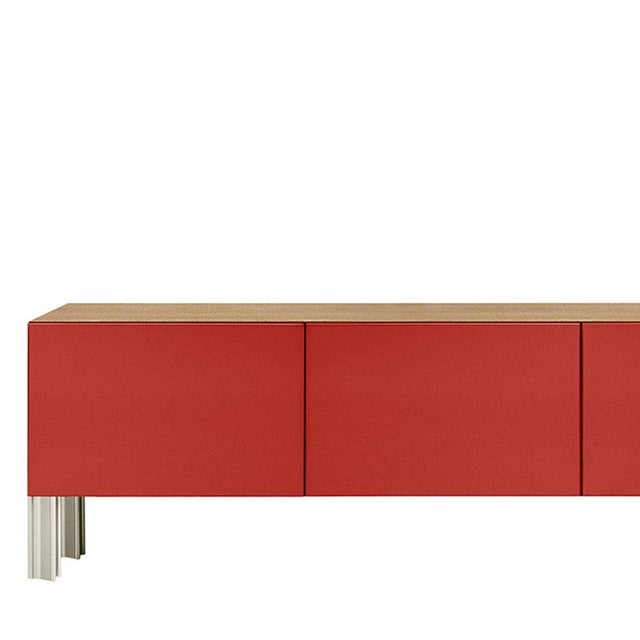 Defined by Robert Stadler's Flexor system, this low living sideboard pairs a red polished-lacquered façade with a slender...