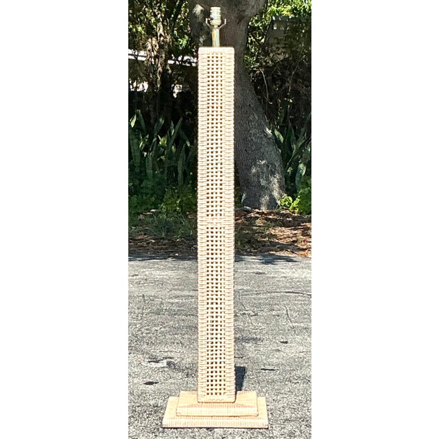 Illuminate your space with the warm, organic appeal of this vintage woven rattan floor lamp. Designed with a tall, slender...