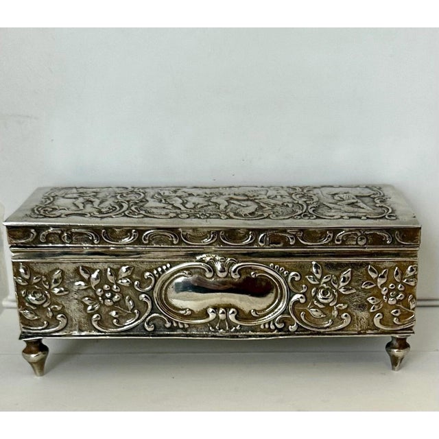 This charming vintage Continental silver plate trinket box dates from the late 19th century. The rectangular shape footed...