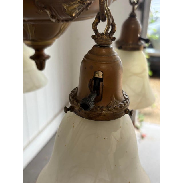 1910s-20s brass 4-light chandelier w/ satin glass light globes. Some patina to metal throughout as shown. Otherwise...