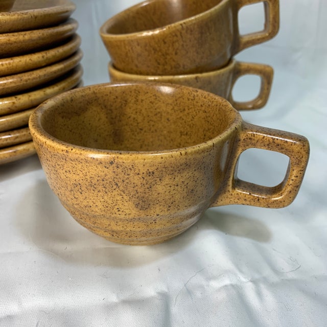This is a vintage Monmouth Pottery "Mojave" cup and saucer set featuring a brown speckled glaze.The pottery was produced...