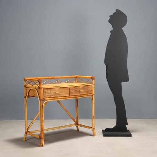 Entrance console table with bamboo structure, wicker top and drawer fronts. This piece is attributed to the mentioned...