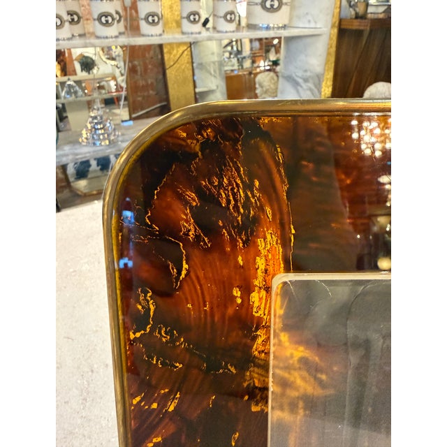 Bold Italian mid-century picture frame crafted in richly patterned tortoiseshell-effect Lucite, framed by a slim polished...