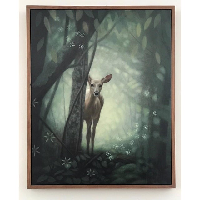 In "Snap of a Twig," a deer emerges from a lush, ethereal forest, partially obscured by trees and foliage. The soft,...