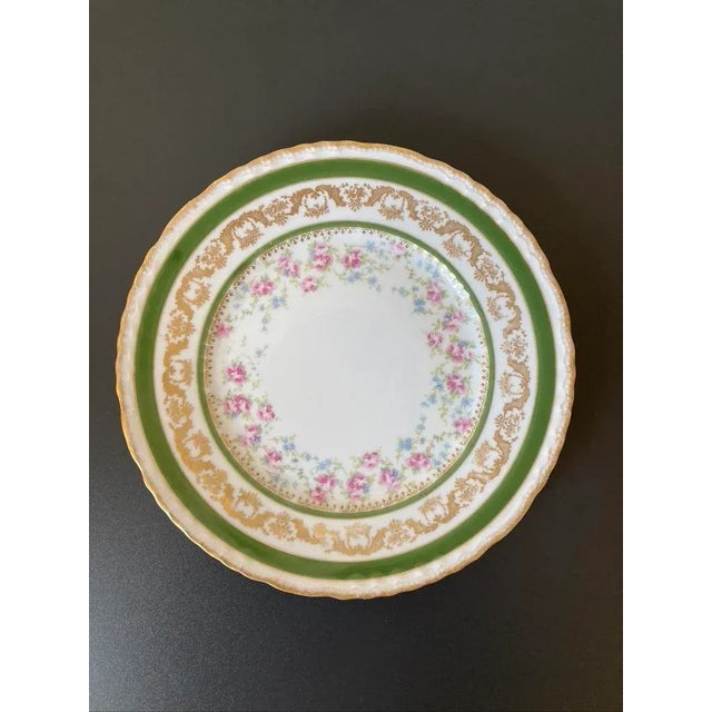 A beautiful French gold and green Limoges porcelain plate with depiction of floral garlands, circa early 20th century,...