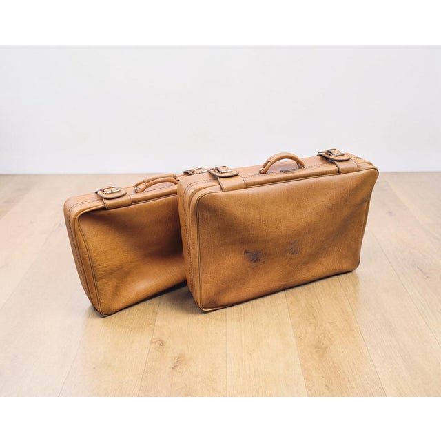 An elegant and highly decorative pair of mid-century lamb leather suitcases, dating from the 1950s and presented in a...