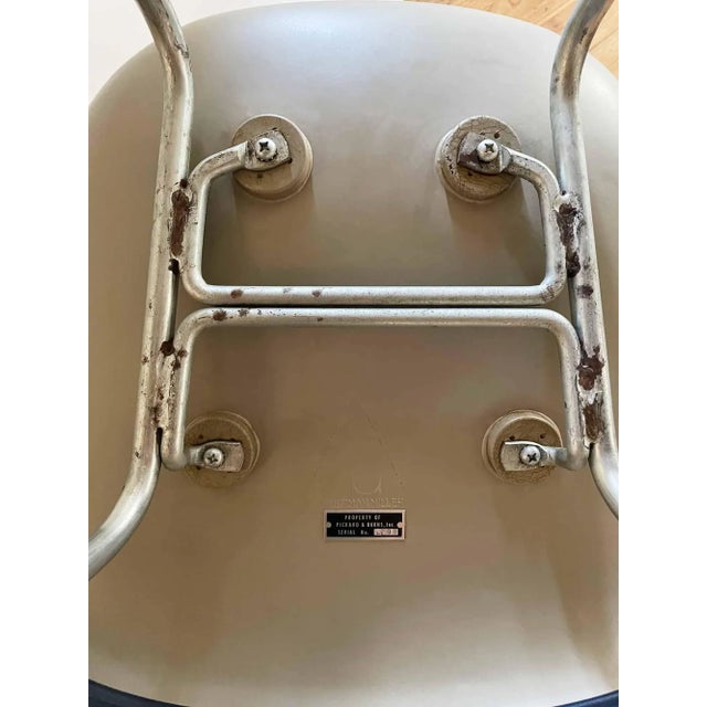Vintage Eames for Herman Miller molded plastic shell armchair. Deep blue vinyl upholstery on metal base with chrome...
