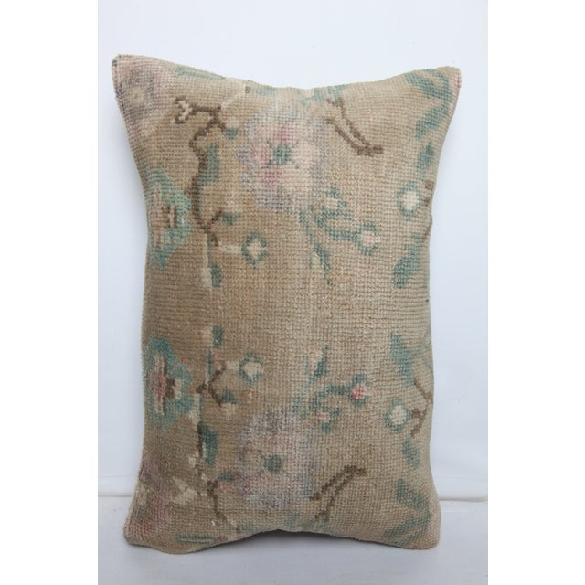 Crafted from a vintage woven rug, this 16x24 lumbar pillow cover features stylized floral motifs in a muted palette...