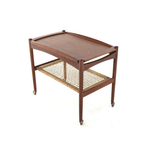 A beautifully designed teak trolley. This trolley owes its timeless appeal to the flowing lines of its design; both...