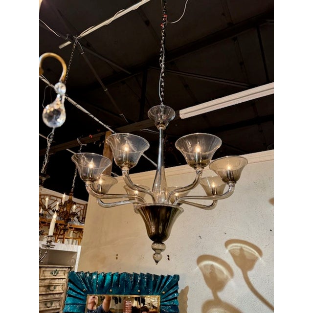 Sleek looking modern fume' colored Murano chandelier with 8 lights. A glistening beauty that is sure to impress! This...