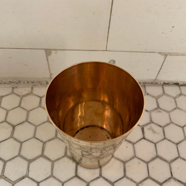 Vintage deadstock Indian brass lassi cup with hand-engraved motif. No maker's mark. Aged to perfection. Used as vases in...