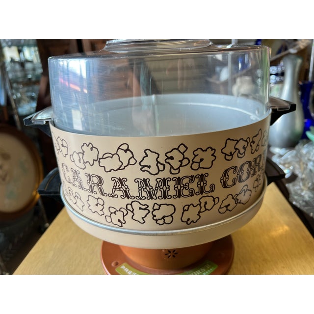 Add a dash of nostalgic, retro flair to your kitchen counter or bar cart with this authentic 1980s Presto Caramel Corn'R....