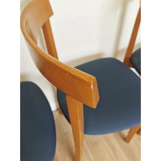 Set of 4 vintage dining chairs are made in mid-century and scandinavian style from wooden base and vibrant blue fabric...