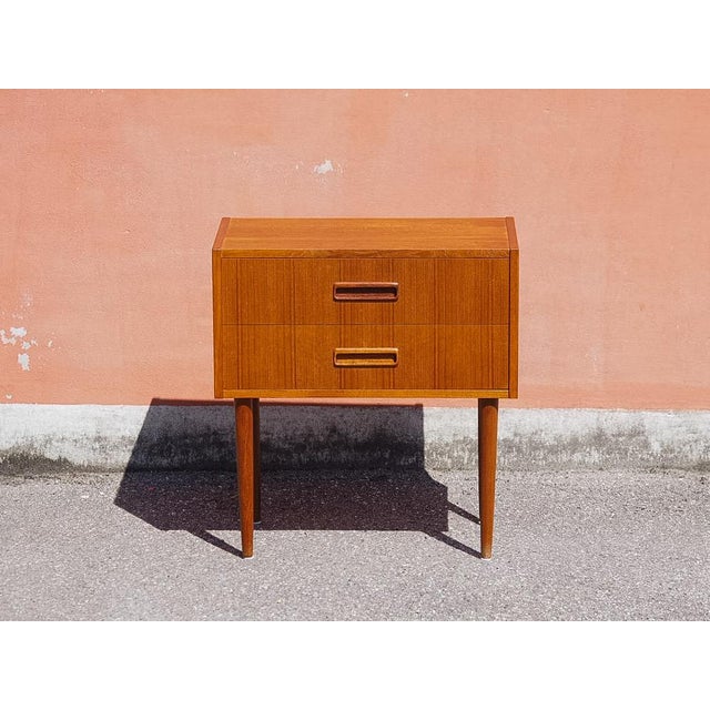 An original teak chest of drawers in the Mid-Century Modern (MCM) style. It features three spacious drawers with milled...