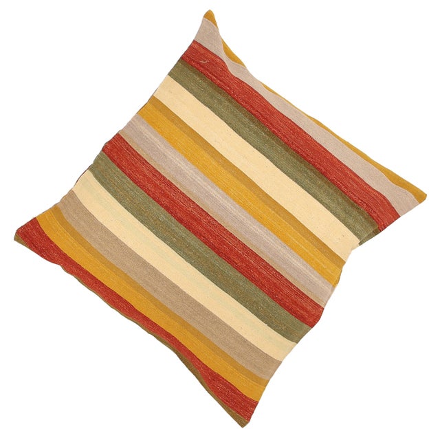 A one-of-a-kind handwoven wool kilim floor pillow featuring a bold horizontal stripe of gold, red and olive. Fully...