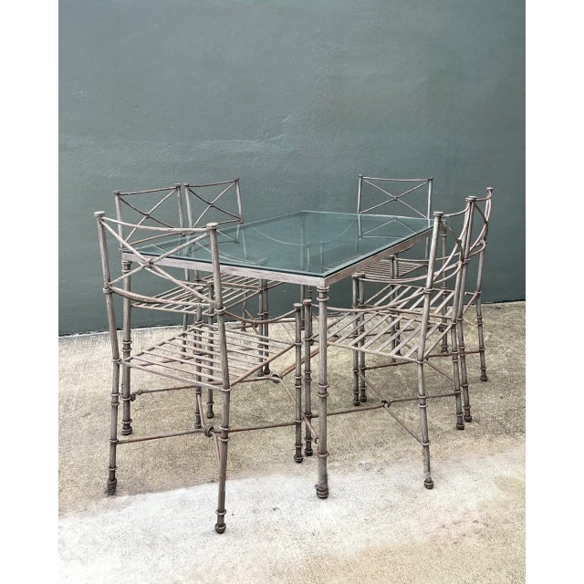 This set of six vintage wrought iron dining chairs captures the clean, geometric spirit of industrial design through a...