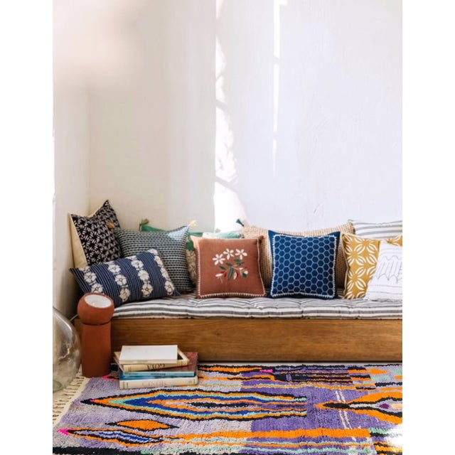 Modern Boujad Rug | Handwoven Wool Rug in Lavender with Orange & Cobalt Flame Motifs This dynamic modern Boujad rug rises...