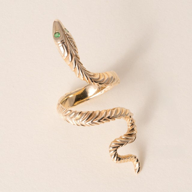 Serpent Vintage Emerald-Eyed Serpent Ring in 14K Solid Gold Circa 1970 A vintage serpent ring featuring an elongated,...