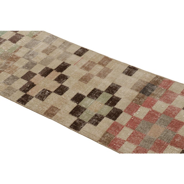 Hand-knotted in wool and originating from Turkey circa 1960 – 1970, this 1x7 vintage Zeki Müren runner is a unique...