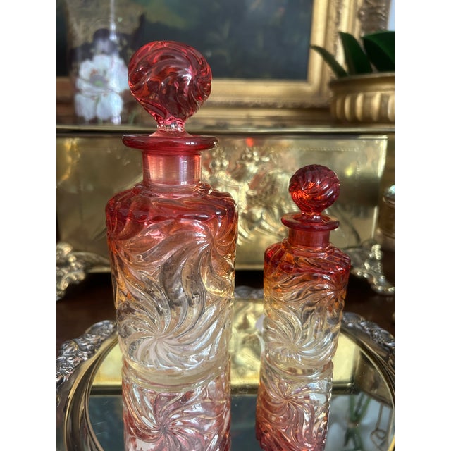 Beautiful collection of four antique French Baccarat crystal perfume/cologne bottles in the harder to find Cadmium...