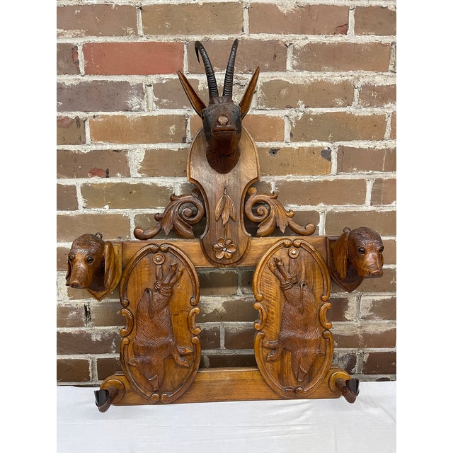 Exceptional and rare monumental 19th century Swiss Black Forest, hand-carved, wall mounted coat and hat rack. This...