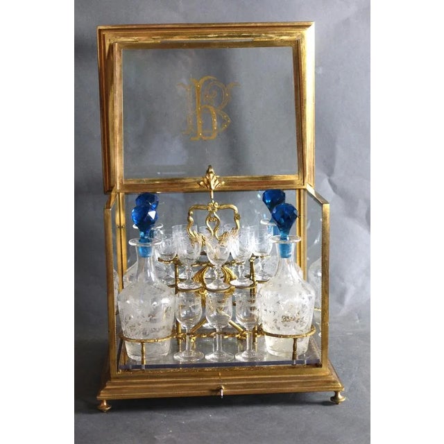 Bronze and glass liqueur cellar from the Napoleon III period, including four carafes with blue stoppers and sixteen...