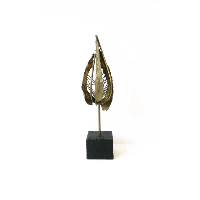 A beautiful modern Brutalist brass sculpture, circa mid-20th century. In the style of designer Paul Evens. Piece is all...