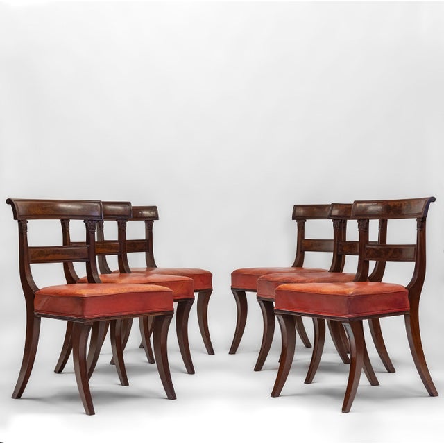 Good set of six Regency mahogany dining chairs with sabre legs and leather seating. Circa 1825. The chairs have graceful...