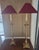 A pair of impressive brass candlestick lamps by Frederick Cooper of Chicago. Original red silk moire' fabric shades are...