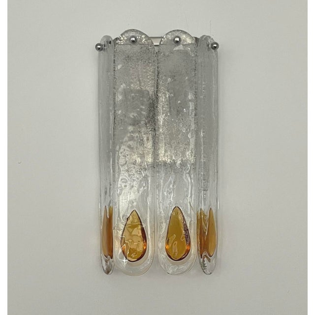 Marvelous and unique set of three italian amber murano glass wall sconces from 1970s. These fixtures were designed and...