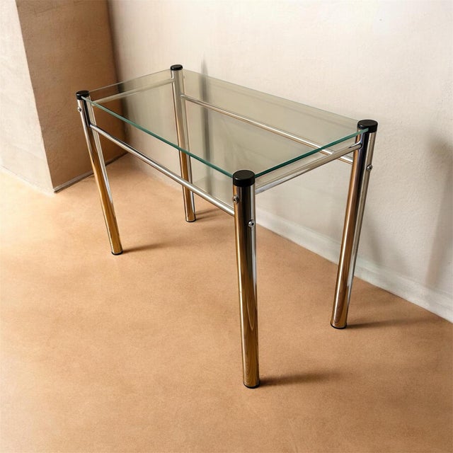 Classic vintage 1970's chrome and glass end or side table. Shows very minimal wear for vintage condition. It is...