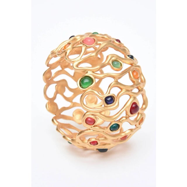 This is part of Chairish’s Costume Jewelry assortment. The open sculptural design of the gold plated wide cuff bracelet...