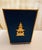 Offered is a beautiful blue waste basket with a gold colored pagoda figurine. This piece is a display model and new in box...