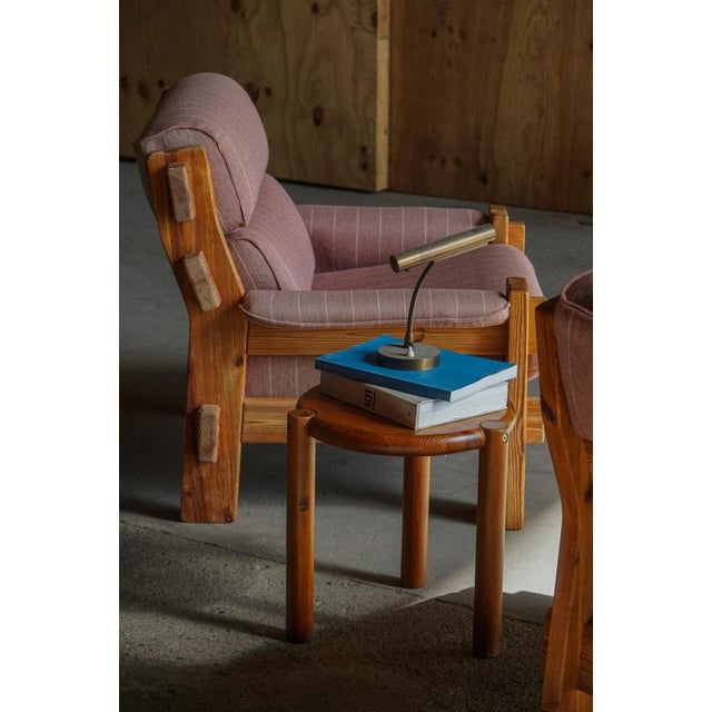 A mid-20th century Scandinavian Modern stool, crafted in solid pine with a circular seat and three cylindrical legs that...