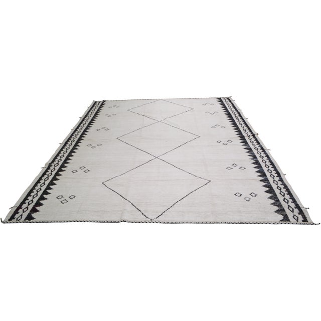 Hand-knotted with care using traditional rug-making techniques, this wool rug blends timeless craftsmanship with a modern...