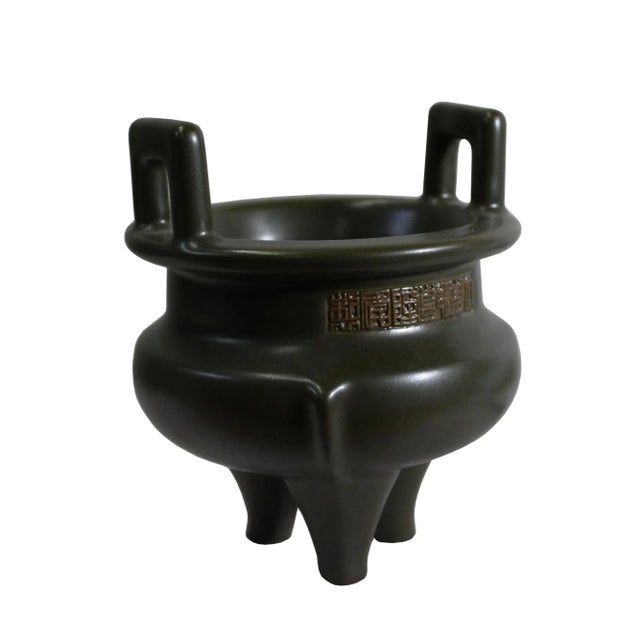 This is a handmade ceramic round shape ding shape incense holder / container with a simple clean flat surface. It has a...