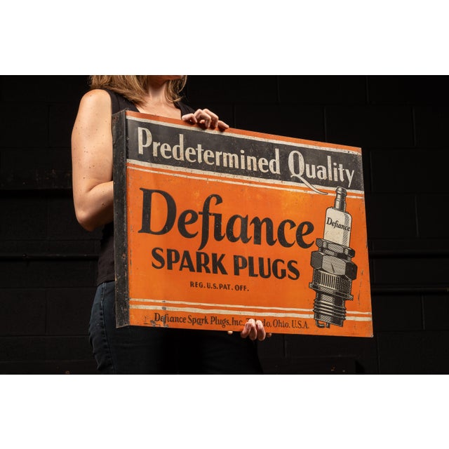 Double-sided flanged tin advertising sign for Defiance Spark Plugs, featuring the bold slogan "Predetermined Quality"...
