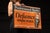Double-sided flanged tin advertising sign for Defiance Spark Plugs, featuring the bold slogan "Predetermined Quality"...
