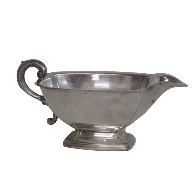 This beautiful footed Gravy Boat is made of metal. This lovely silver colored piece appears to be silver plated due to the...