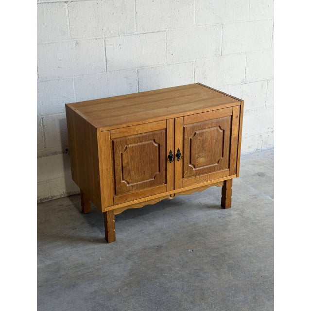 Beautiful vintage Danish cabinet crafted in oak by Henning, featuring clean Scandinavian lines and elegant carved panel...