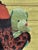 In "Dolls, Not Babies," a young girl cradles a plush toy, embodying a blend of innocence and maturity. The intricate...