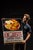 Vintage single-sided porcelain sign advertising "EXQUISITE" canned foods. It is unknown if this is advertising a...