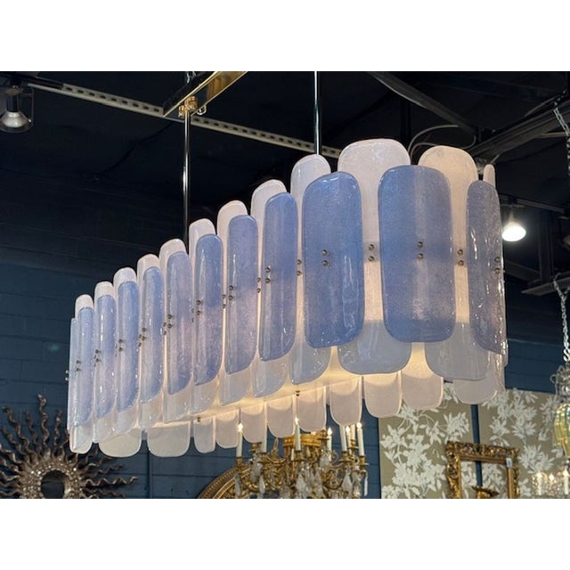 This large-scale two-tone Murano glass oval chandelier is a stunning and elegant addition to any room. The sleek design...