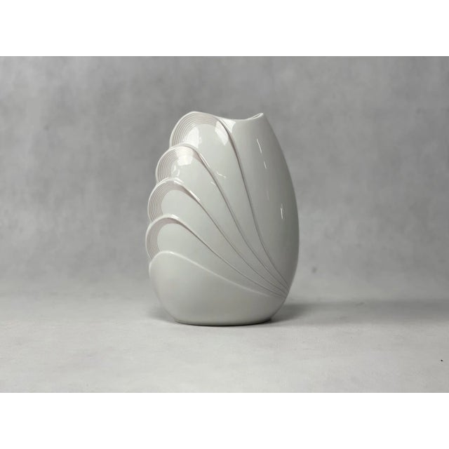Porcelain vase with an oval shape, with diagonal wide stripes in the shape of wings, white glaze. German production from...