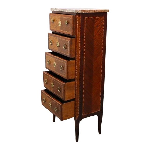 This antique Louis XVI style lingerie chest, dating to approximately 1900, is crafted from mahogany and features intricate...