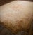 This circa-1925, 13' 2" x 17' 6" European Savonnerie rug eatures a dense, hand-knotted wool pile and a sophisticated beige...