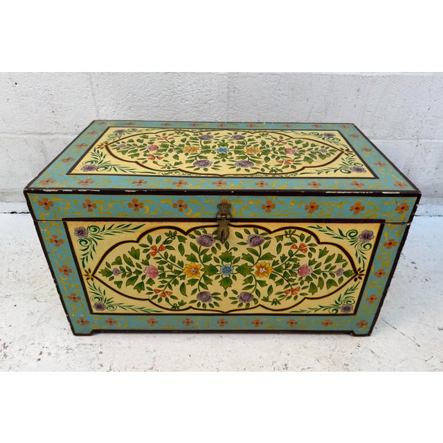 Charming vintage wooden storage trunk featuring hand-painted floral folk art decoration, showcasing colorful botanical...