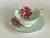 A charming vintage Paragon teacup and saucer in fine English bone china, decorated with generous red-pink cabbage roses...